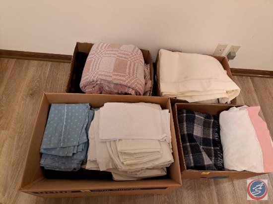 Assortment of sheets, pillow cases, and blankets. Some of the blankets appear to be wool.