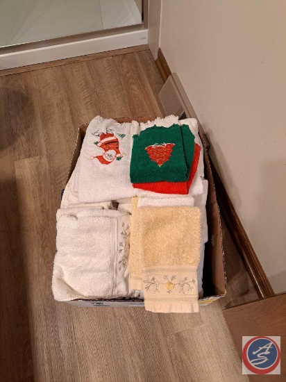 An assortment of decorative towels for kitchen or bathroom, and 5 wool sweaters. Unsure what size