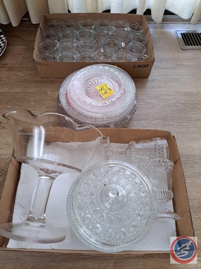Assortment of clear glass mugs, serving plates, and candy dishes. Does appear there is pink