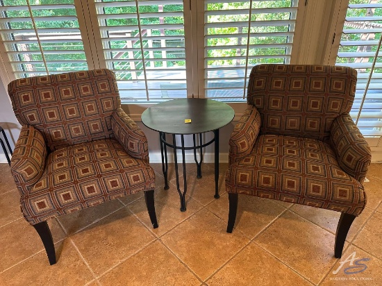 2 brown and tan geometric patterned arm chairs with round metal table