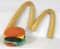 McDonalds M sign with cheeseburger