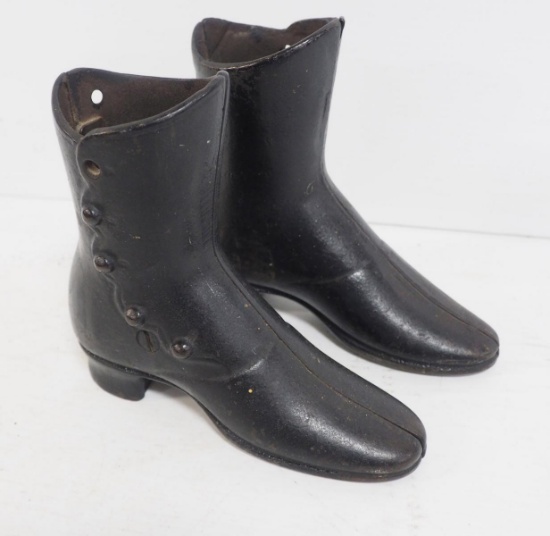 Pair of cast iron button shoes