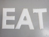 Porcelain letters spelling EAT