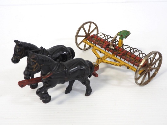 Arcade dump hay rake with horses