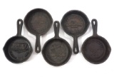 (5) Small cast iron advertising skillets