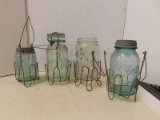 (4) VINTAGE GLASS CANNING JARS IN JAR HOLDERS