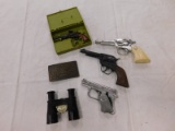 FLAT OF TOY PISTOLS, COLT REVOLVER BELT BUCKLE & BIASCOPE MODEL E 6X MINI BINOCULARS