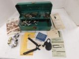 METAL TACKLE BOX PARTIALLY FULL OF ROD HEADS, TARGET POINTS & WATERFOWL BANDS