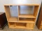 LIGHT COLORED PRESSED WOOD ENTERTAINMENT CENTER