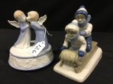 Pair Of Blue & White Figures: Kids On Sled & Musical Kissing Angels