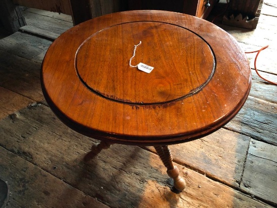 What appears to be a piano stool converted into a small table.