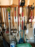 Large Group of Yard Tools on Wall, Wheel Barrow and Cooler