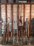 Group of yard tools on wall in garage