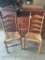 Two cane bottom, ladder back chairs in rough condition