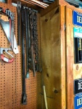 Crowbars, Chain and a Grabber On Pegboard In Garage