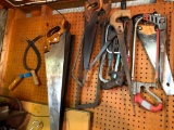 Group of Saws and More on Pegboard at tear of Garage