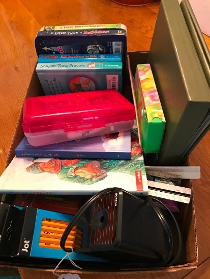 Group of office supplies and kids religious books.