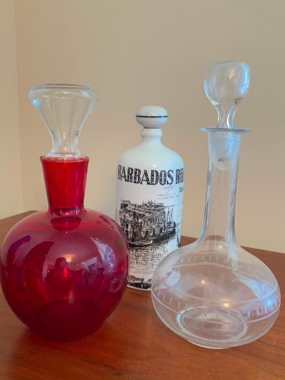 Two Glass and One Porcelain Decanter with Stoppers
