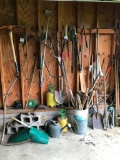 Group of Yard Tools on Side Wall of Back Garage as Pictured