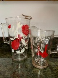 Set of 2 Red and White Print Pitchers. One is 7