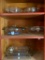 Group of Pillsbury Dough Boy Glass Baking Dishes and More as Pictured in Upper Cabinet Rt of Stove