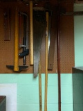 Tools Hanging on Side Wall in Basement Includes Sledge Hammer, Hand Saws, Breaker Bar, Etc