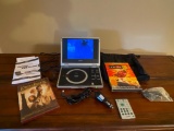 Apex PD 700-840 Portable DVD Player. This is in Working Condition. Incl. 2 Movies - As Pictured