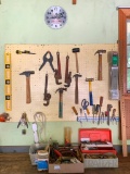 Tool Lot on Workbench in Garage and Items Hanging on Peg Board