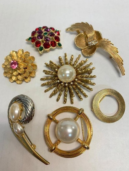 Set of 7 Gold Tone Brooches. The Largest is 2"