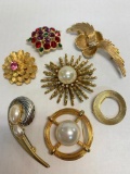 Set of 7 Gold Tone Brooches. The Largest is 2