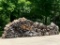 Large Pile of Wooden Boards and Seasoned Logs