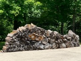 Large Pile of Wooden Boards and Seasoned Logs