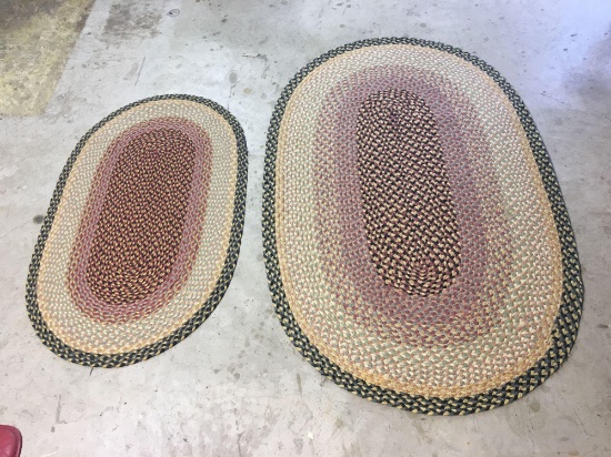 2 matching oval braided throw rugs