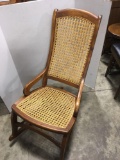 Antique rocking chair with re-caned seat and back