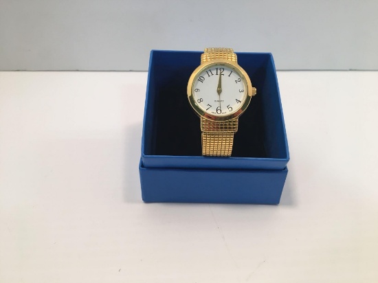 Stainless steel back gold tone watch