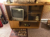 Wood like entertainment center with contents/SYLVANIA TV