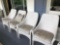 4 matching white wicker chairs