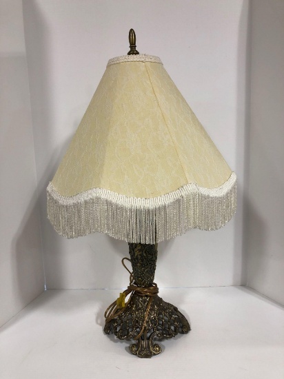 Cast metal base lamp with ivory fringe shade