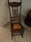 ANTIQUE OAK PRESSED BACK ROCKER WITH BASKET WEAVE SEAT