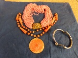 2 PINK NECKLACES ONE IS CARVED STONE AND GOLF BRACELET