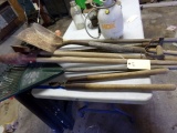 LOT OF GARDEN TOOLS TO INCLUDE SHOVEL RAKE POST HOLE DIGGER CLIPPER AND SAW