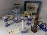 LARGE LOT OF BLUE AND WHITE ITEMS ON KITCHEN COUNTER ON BOTH SIDES OF SINK