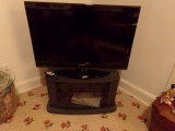 TOSHIBA FLAT SCREEN ON ENTERTAINMENT CENTER AND CONTENTS