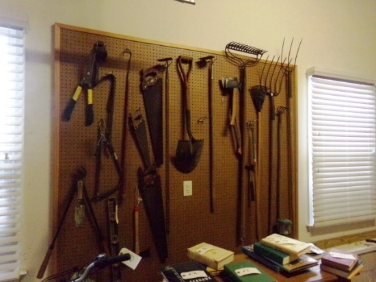 ALL HAND TOOLS ON PEG BOARD WALL INCLUDING SAWS SHOVELS AND MORE