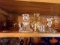 SHELF INCLUDING SHORT CANDLE HOLDERS APPROX 2 TO 4 INCHES TALL CLEAR GLASS