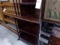 FOUR TIER CORNER CURIO CABINET WITH BRASS CAP FEET