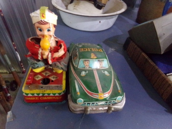 LOT OF TWO VINTAGE TOYS THE SNAKE CHARMER AND POLICE DEPT CAR MADE IN JAPAN