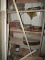 METAL SHELF UNIT WITH CONTENTS OF STORM DOORS GREASE GUNS AND MORE
