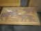 COFFEE TABLE WITH MOOSE ELK BEAR AND DEER CARVED IN TOP APPROX 27 X 48 INCH