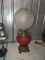 ANTIQUE OIL LAMP CONVERTED WITH RED GLASS BASE WITH GRAPE PATTERN SHADE